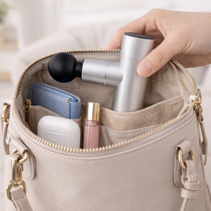 Mini massage gun fits in a handbag — compact and portable